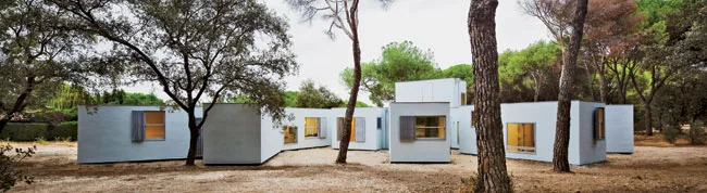 This lightweight structure in northern Madrid is built of computer-cut, cross-laminated wood walls, floors, and roofs, and floats on micropiles so as not to harm tree roots. Eleven pavilions (living, 