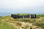 For protection from sea winds, the architects excavated a sunken garden on the southern exposure of this lot on the Cantabria coast and built the house over it. Patios for light and circulation slice 