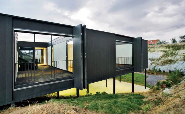 For protection from sea winds, the architects excavated a sunken garden on the southern exposure of this lot on the Cantabria coast and built the house over it. Patios for light and circulation slice 