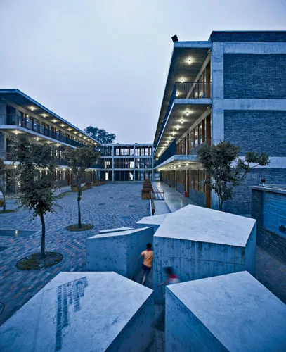 'We're trying to do something different, to challenge the clich'd educational approach,' says Hua. TAO's gathering of buildings and outdoor spaces allows children to pursue individual activities in ad