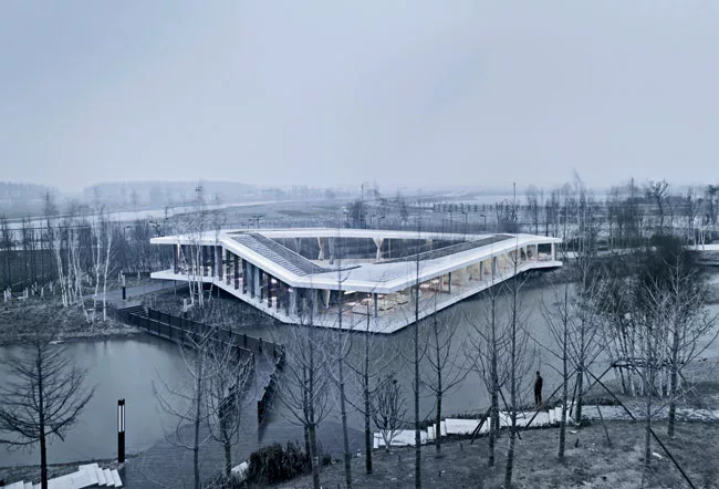 TAO took its design cues for this 5,380-square-foot building in Yancheng, 200 miles north of Shanghai, from the riverside site. The steel-framed, glass-walled building hovers above the ground, running