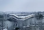 TAO took its design cues for this 5,380-square-foot building in Yancheng, 200 miles north of Shanghai, from the riverside site. The steel-framed, glass-walled building hovers above the ground, running