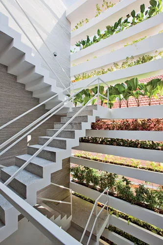 While their city is becoming increasingly dense and polluted, residents of Ho Chi Minh City still love their plants and trees. So Vo designed this 13-foot-wide private house with cantilevered planters