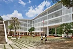 Located in the new town of Binh Duong, a 30-minute drive outside of Ho Chi Minh City, this school uses an S-shaped plan to wrap around a pair of courtyards and provide an uninterrupted circulation loo