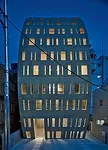 A commercial building in an upscale Tokyo neighborhood, the 3,875-square-foot Urbanprem Minamiaoyama was completed in 2008. Situated at the end of a quiet cul-de-sac, it greets the narrow street in fr