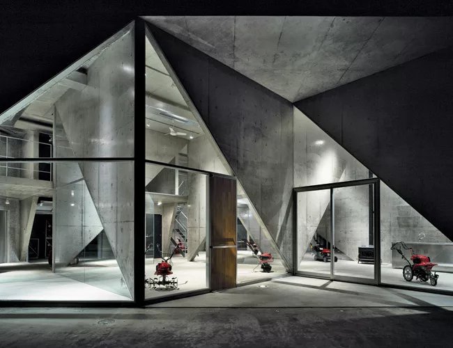 An unlikely pairing of avant-garde architecture and agricultural machinery, Masuya is a showroom for tractors and snow blowers located in rural Niigata Prefecture. Completed in 2005, the concrete buil