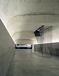 This intervention occupies the basement of a Neoclassical loggia in Madrid. Collaborating with Jes&uacute;s Aparicio, Elorza removed a portion of a thick floor slab to create a double-height auditoriu