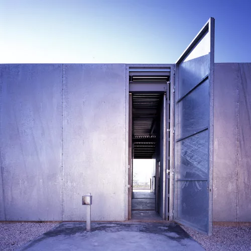 At this windowless facility in Madrid where scientists handle dangerous substances, narrow patios separate four labs, while a vehicular service corridor runs the length of the building. Elorza enclose