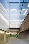 To give this addition to an existing 1940s building in Madrid its own identity, Elorza separated the two structures with a long patio and raised the new one on four piers. The patio is lined on one si