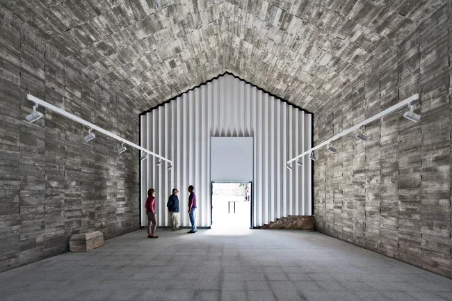 Elorza converted this deconsecrated chapel in Jarandilla de la Vera into a center for cultural activities. He lined its interior with a tube of structural concrete'floor, walls, and pitched ceiling'to