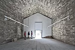 Elorza converted this deconsecrated chapel in Jarandilla de la Vera into a center for cultural activities. He lined its interior with a tube of structural concrete'floor, walls, and pitched ceiling'to