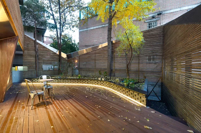 This residential project with street-front commercial spaces takes advantage of a grandfather clause that exempts existing buildings from having to provide parking. JOHO convinced the client to renova