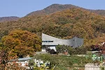 The curve of this 1513-square-foot house has an unexpected origin'car parking. Its tight site made maneuvering vehicles difficult, so JOHO added a curve and raised the building on <em>pilotis</em>. Th