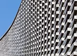 The curve of this 1513-square-foot house has an unexpected origin'car parking. Its tight site made maneuvering vehicles difficult, so JOHO added a curve and raised the building on <em>pilotis</em>. Th