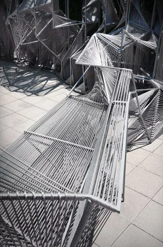This 21-foot-long installation in Los Angeles, made of rope strung across steel framing, forms an optical illusion. Look at it straight on and you see a repeating, legible pattern. But move around it