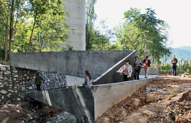 In northern Shaanxi province, this bridge forms a concrete loop that crosses a small river and provides access to the water for fishing, washing, and recreation. By connecting residents to agricultura