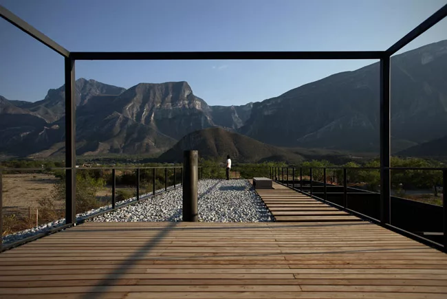 Designed as a refuge for its city-dweller clients, the house also functions as an observatory. Minimal steel railings and structure surround the rooftop deck, providing places to hang a hammock as wel