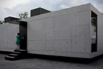 This private residence wears its rough material palette on its sleeve. Inside and out, the reinforced concrete walls and floors of the low box are left exposed and unadorned, punctuated by simple deta