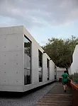 The house is set back from the street and neighboring properties, creating ample circulation space around the volume.