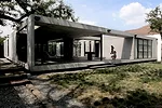 The house&rsquo;s opaque street-side facade contrasts with its open interior, where a central patio links social and private spaces to the backyard and views out to the Sierra Madre Mountains beyond.