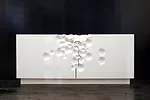 A lacquered wood cabinet designed by Aranda\Lasch is 30 by 72 by 18 inches in size, with a crystalline-CNC-milled motif. Craig Robins, CEO of Dacra, the Miami real-estate firm, purchased the limited-e