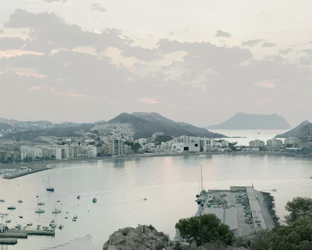 For a town on Spain's Mediterranean coast, the architects created a compact volume to minimize its occupation of the waterfront, and to create a point of reference in the landscape. The concave walls,