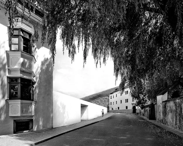 Planned for completion in 2017, this competition-winning project expands an existing historic building—Casa Ragen, in Brunico, Italy—and retains the town's urban fabric with low, wall-like