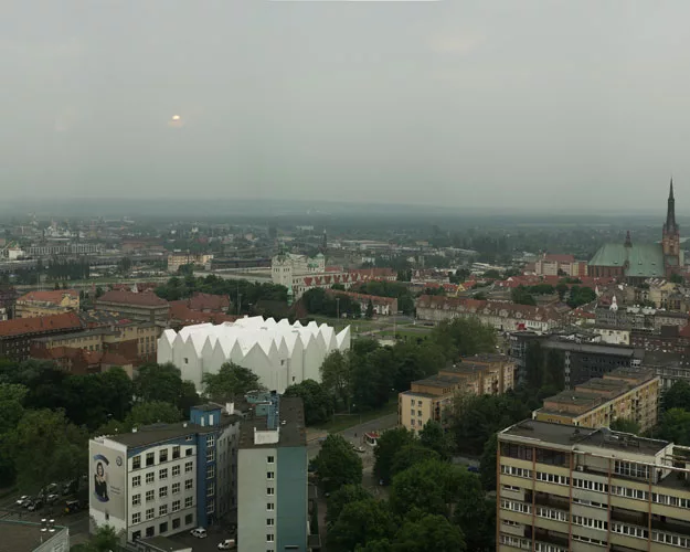 Occupying the site of a concert hall destroyed during World War II in this northwestern Polish city, the building's translucent glass form 'appears as a white mass in the daytime,' says Alberto Veiga,