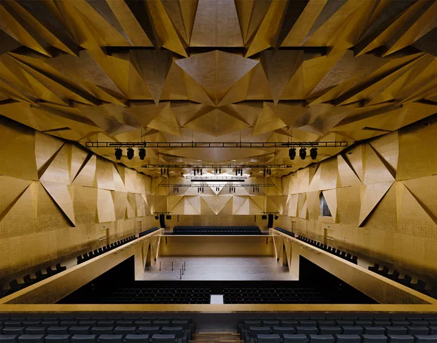 Occupying the site of a concert hall destroyed during World War II in this northwestern Polish city, the building's translucent glass form 'appears as a white mass in the daytime,' says Alberto Veiga,