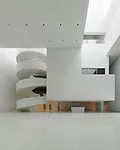 Occupying the site of a concert hall destroyed during World War II in this northwestern Polish city, the building's translucent glass form 'appears as a white mass in the daytime,' says Alberto Veiga,