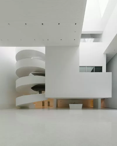 Occupying the site of a concert hall destroyed during World War II in this northwestern Polish city, the building's translucent glass form 'appears as a white mass in the daytime,' says Alberto Veiga,