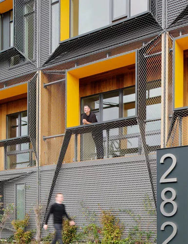 A new 12,000-square-foot, 3½-story apartment complex on the waterfront in East Boston has a vertical garden growing along a mesh screen on the facade.