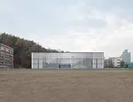 Scheduled to be completed at the end of 2014, this 28,000-square-foot high school responds to different conditions on its three sides by presenting three different facades. Facing a playground to the 