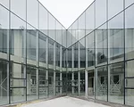 Scheduled to be completed at the end of 2014, this 28,000-square-foot high school responds to different conditions on its three sides by presenting three different facades. Facing a playground to the 
