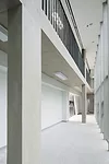 Scheduled to be completed at the end of 2014, this 28,000-square-foot high school responds to different conditions on its three sides by presenting three different facades. Facing a playground to the 