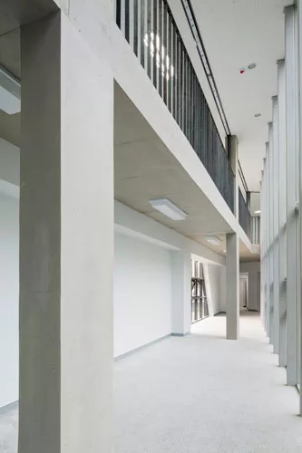 Scheduled to be completed at the end of 2014, this 28,000-square-foot high school responds to different conditions on its three sides by presenting three different facades. Facing a playground to the