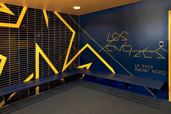 In a renovated structure behind the new building, RUFproject worked with the graphic design agency Grid Worldwide to stamp each dressing room with the logos and colors of famous football teams sponsor