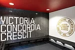 In a renovated structure behind the new building, RUFproject worked with the graphic design agency Grid Worldwide to stamp each dressing room with the logos and colors of famous football teams sponsor