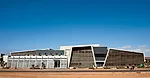 The architects used overhangs and wood screens to reduce the impact of the sun, and created covered and outdoor paths through the project. Instead of sitting behind a wall for security, the center rel