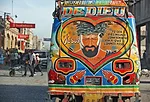 The back of a 'tap tap,' or private bus, in downtown Port-au-Prince. Many of the vehicles look similar in style and generally convey a religious sentiment. <em>January 2012</em>.