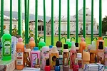 For-sale beauty products line a wall surrounding the crumbled Presidential Palace. <em>April 2010</em>.