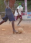 Young men play soccer at a high level, despite a lack of proper shoes and equipment. <em>January 2012</em>.
