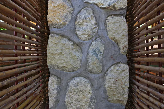 Detail shot of the bamboo screens and stone wall.
