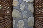 Detail shot of the bamboo screens and stone wall.