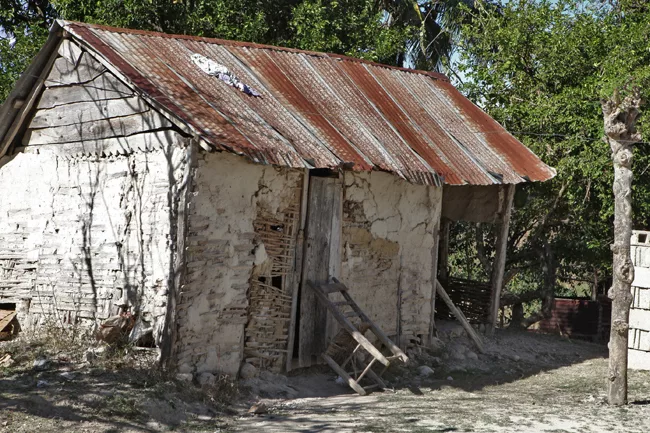 Next to the school are rustic homes.