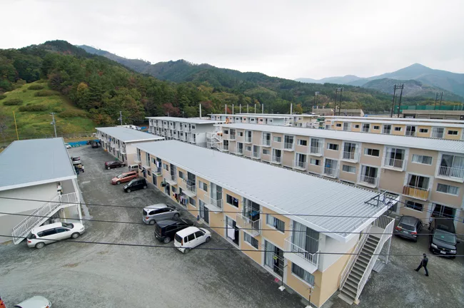 Quick to construct (and deconstruct), the buildings consist of shipping containers stacked and secured by a steel frame. For insulation and seismic resistance, they are arranged in a checkerboard patt
