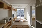 Each apartment contains a bath, kitchen, and one or more bedrooms. Natural wood shelving not only provides storage, it also serves as additional seating.