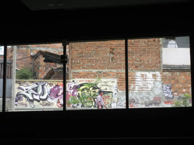 Large windows animate the interiors with the village's colors and activity.
