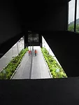 Apertures offer surprising views through and out of the building. Here, visitors get a look down to the protected exterior passage on the front facade.