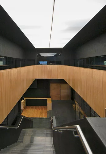 A large skylight covered with PVC membrane illuminates the central stair.